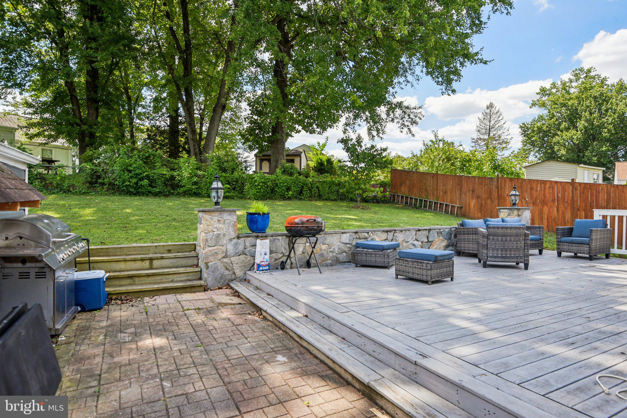 6715 Westcott Road Falls Church, VA 22042 - Photo 2 of 24 a view of a patio with table and chairs potted plants and a large tree