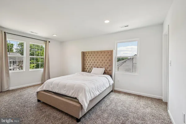 a bedroom with a bed lamp and window
