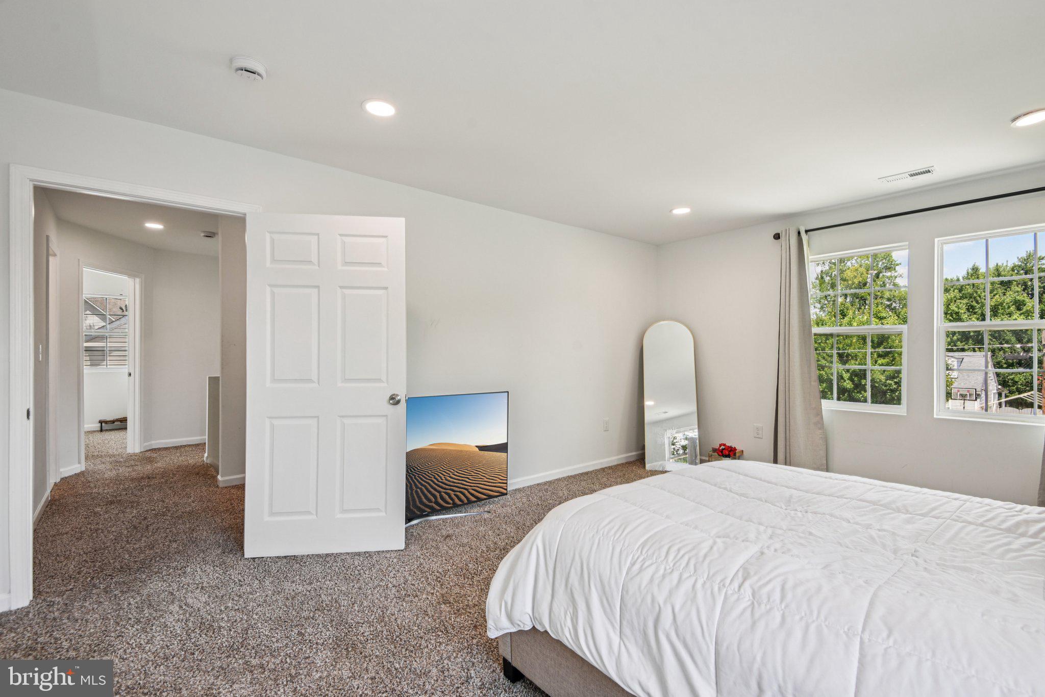 6715 Westcott Road Falls Church, VA 22042 - Photo 9 of 24 a bedroom with a bed and a large window