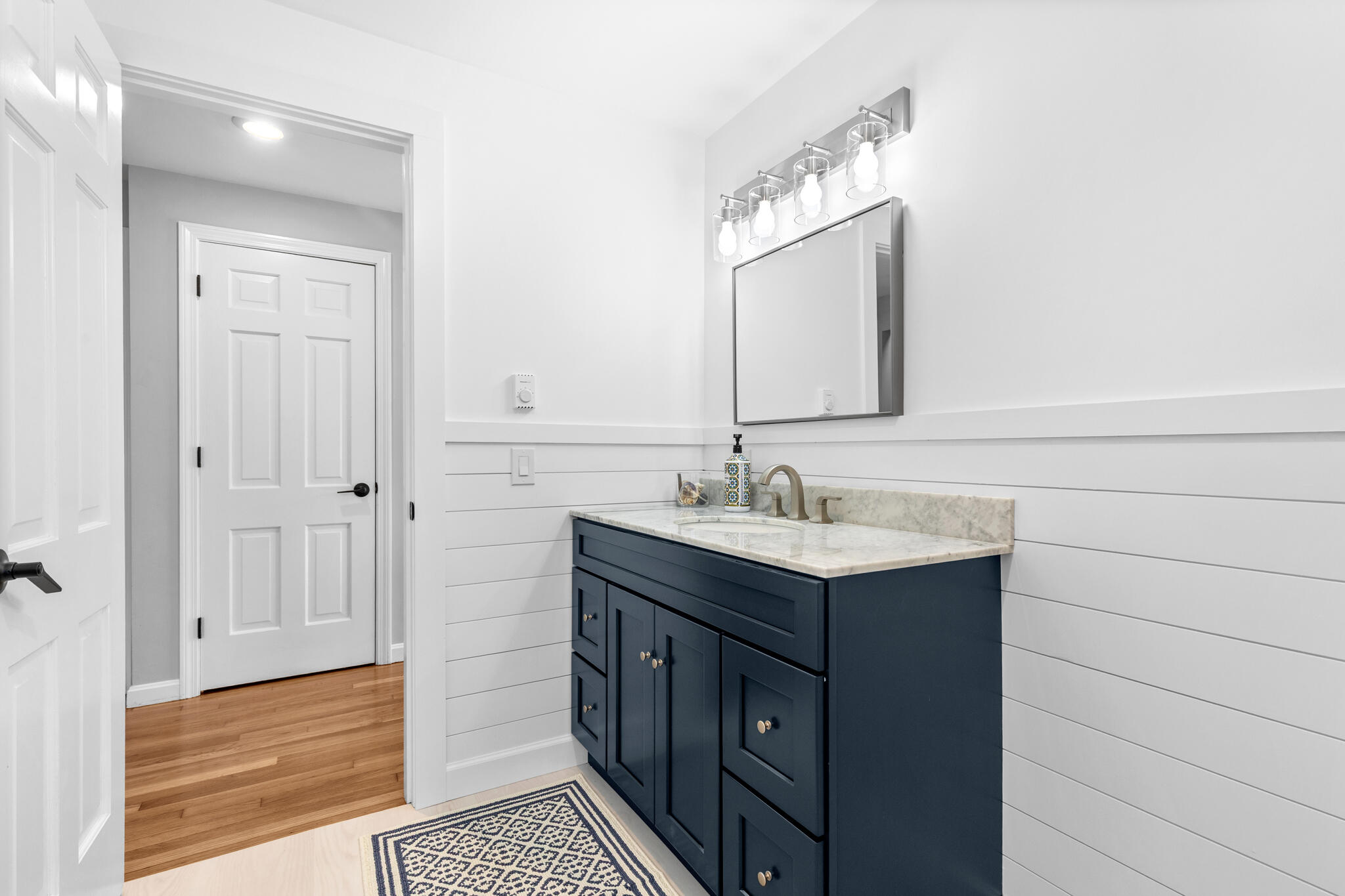 1295 Massasoit Road Eastham, MA 02642 - Photo 22 of 32 a bathroom with a sink and a mirror