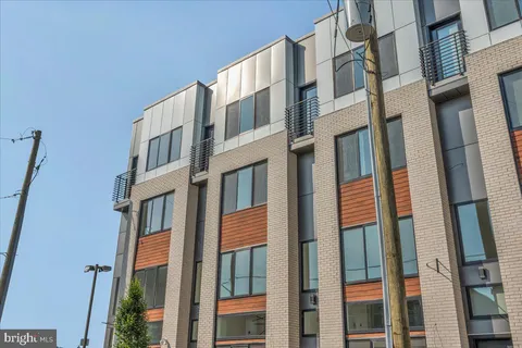 a view of a building with cars parked in front of a building