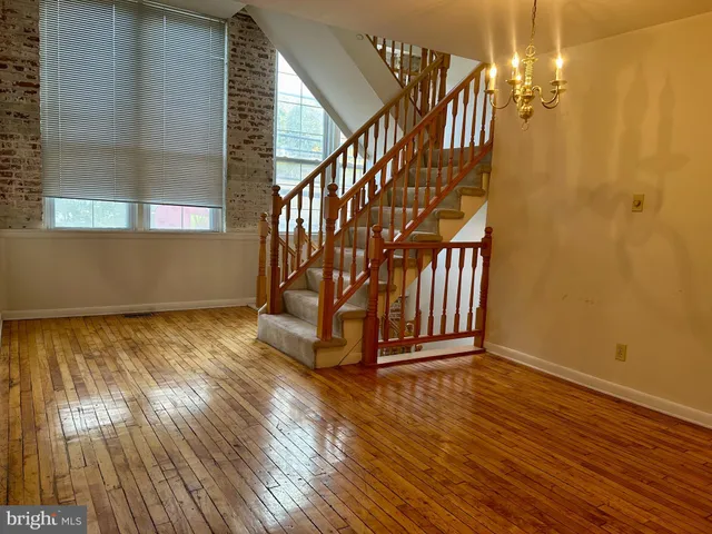 a view of an entryway with wooden floor
