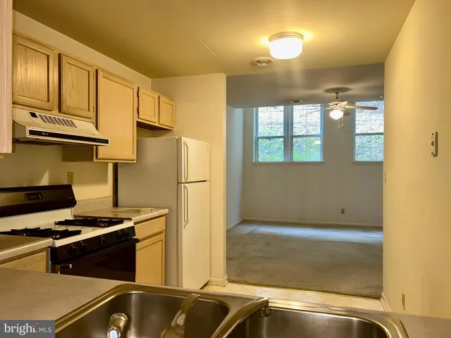 a kitchen with a sink appliances and cabinets