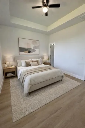 a bedroom with a bed and ceiling fan