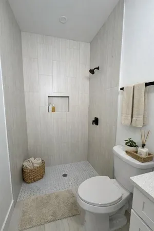 a bathroom with a toilet and a shower