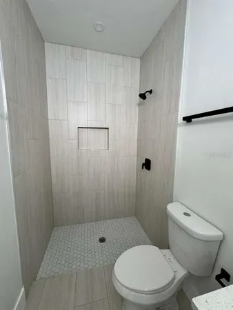 a bathroom with a toilet and a shower