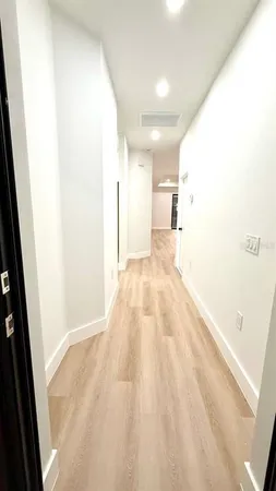 a view of empty room with wooden floor