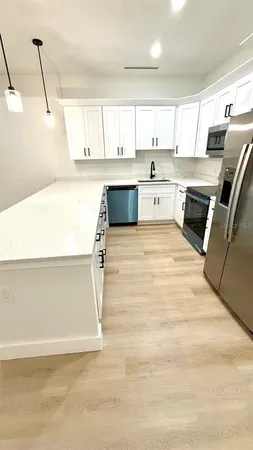 a view of kitchen with wooden floor