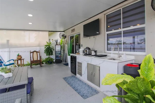 a kitchen with sink refrigerator and cabinets