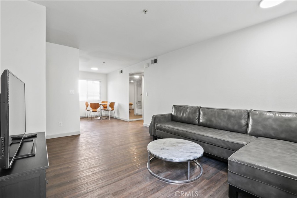 112 North Primrose Avenue, Unit C Alhambra, CA 91801 - Photo 2 of 8 a living room with furniture and a wooden floor