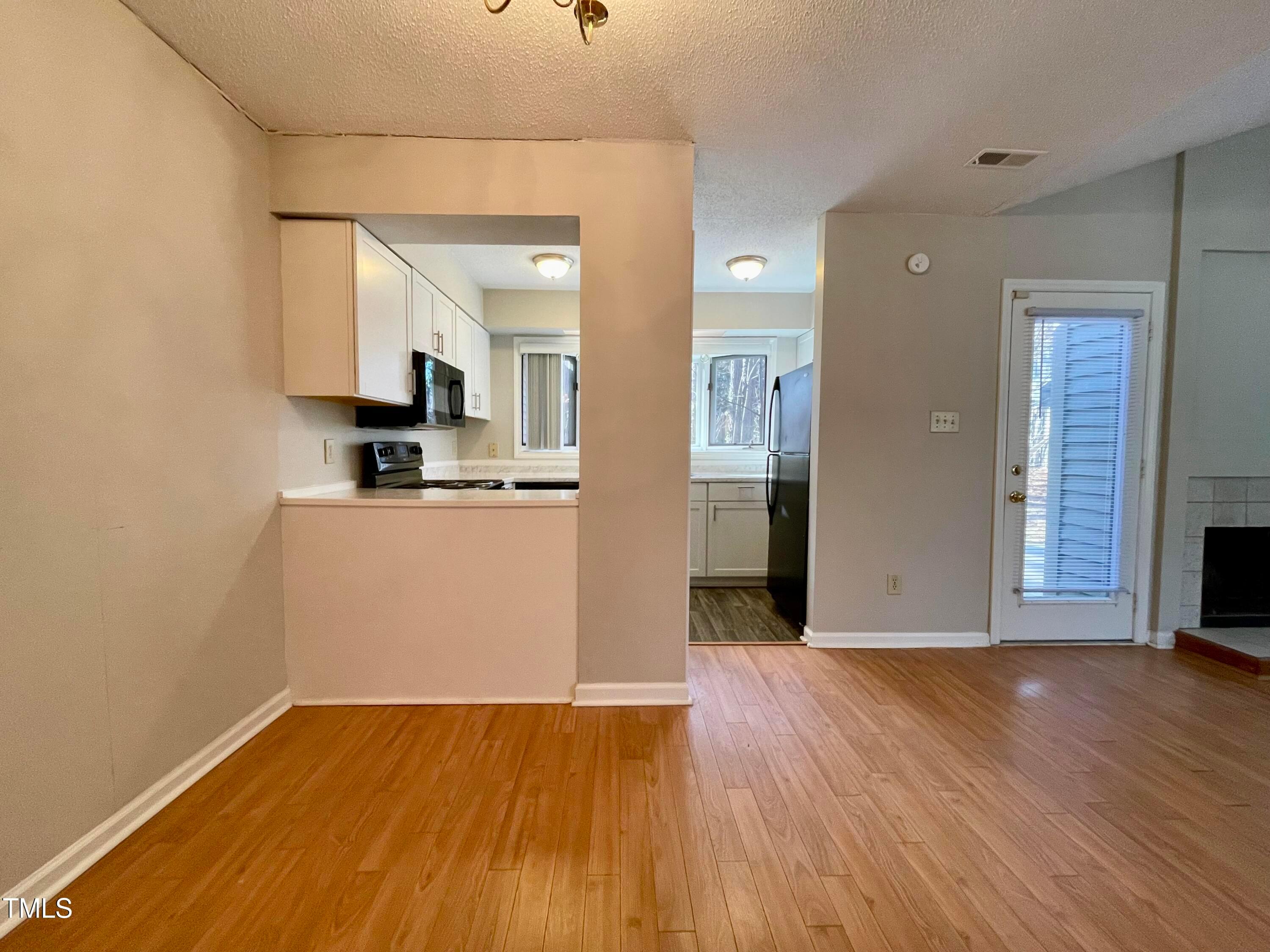 4114 Beechnut Lane Durham, NC 27707 - Photo 11 of 25 a view of a kitchen with wooden floor and a sink
