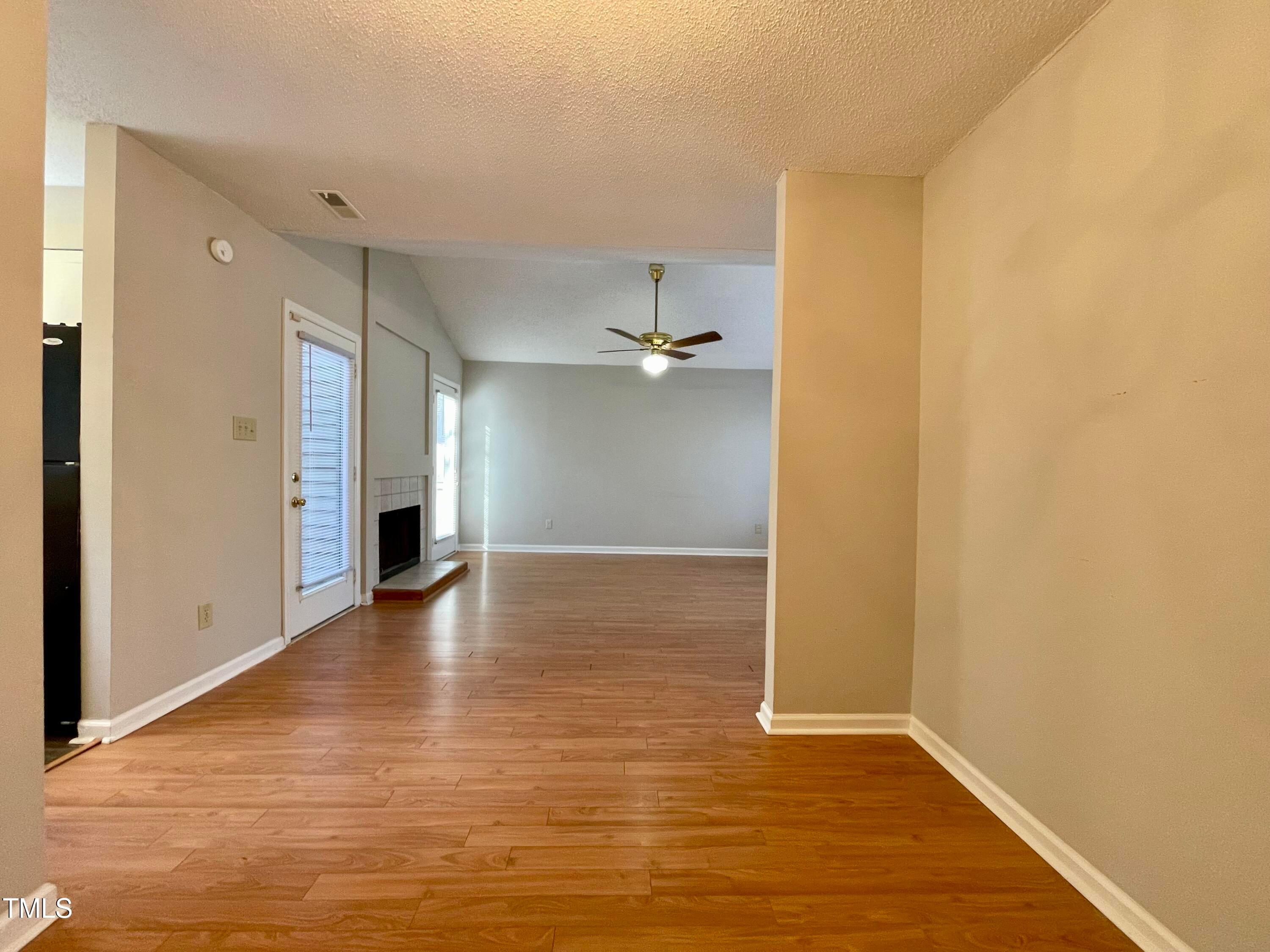 4114 Beechnut Lane Durham, NC 27707 - Photo 12 of 25 a view of an empty room with wooden floor and a window