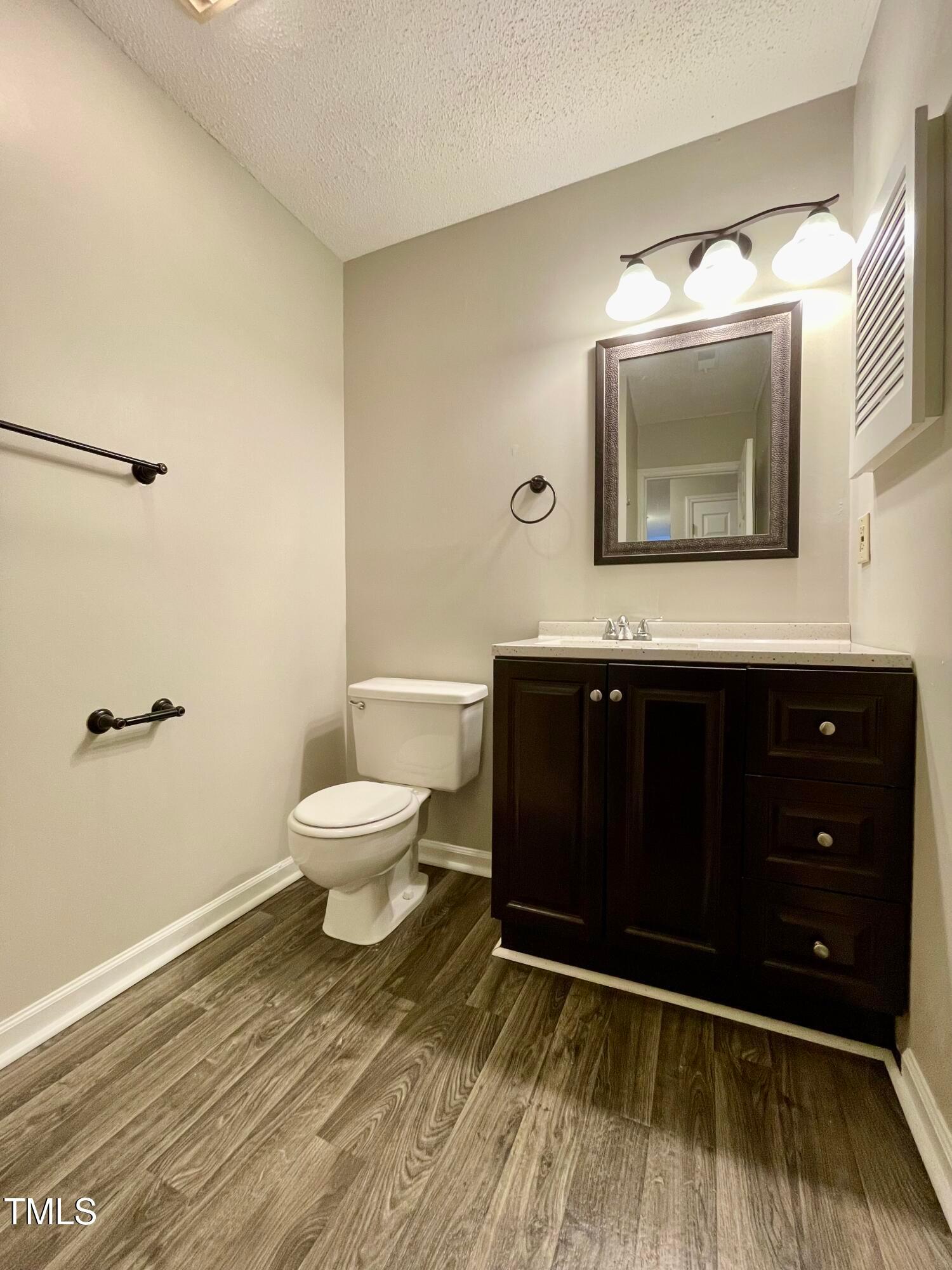 4114 Beechnut Lane Durham, NC 27707 - Photo 13 of 25 a bathroom with a sink a toilet and mirror