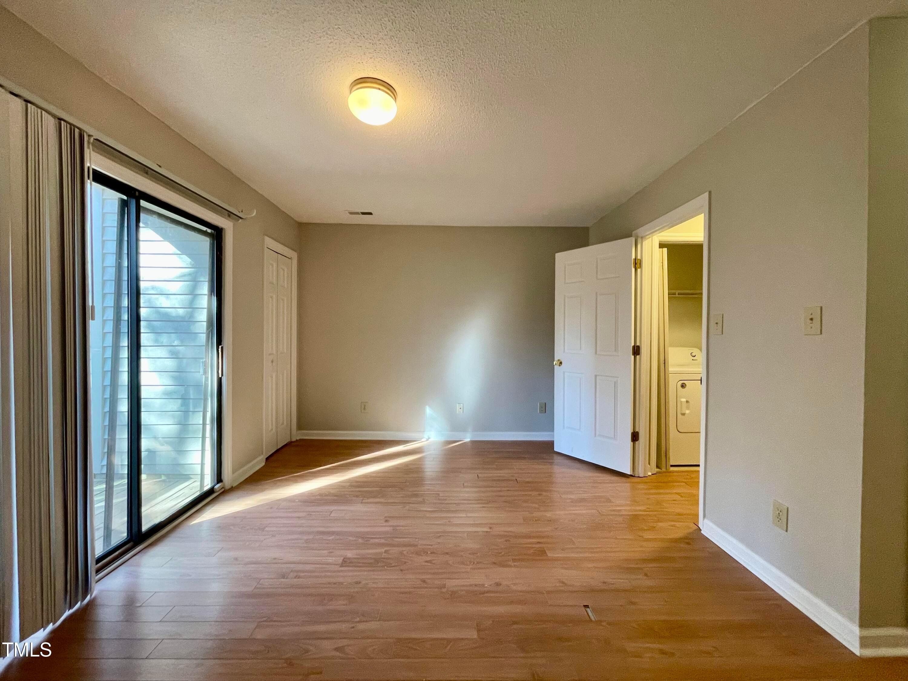 4114 Beechnut Lane Durham, NC 27707 - Photo 15 of 25 a view of an empty room with wooden floor and a window