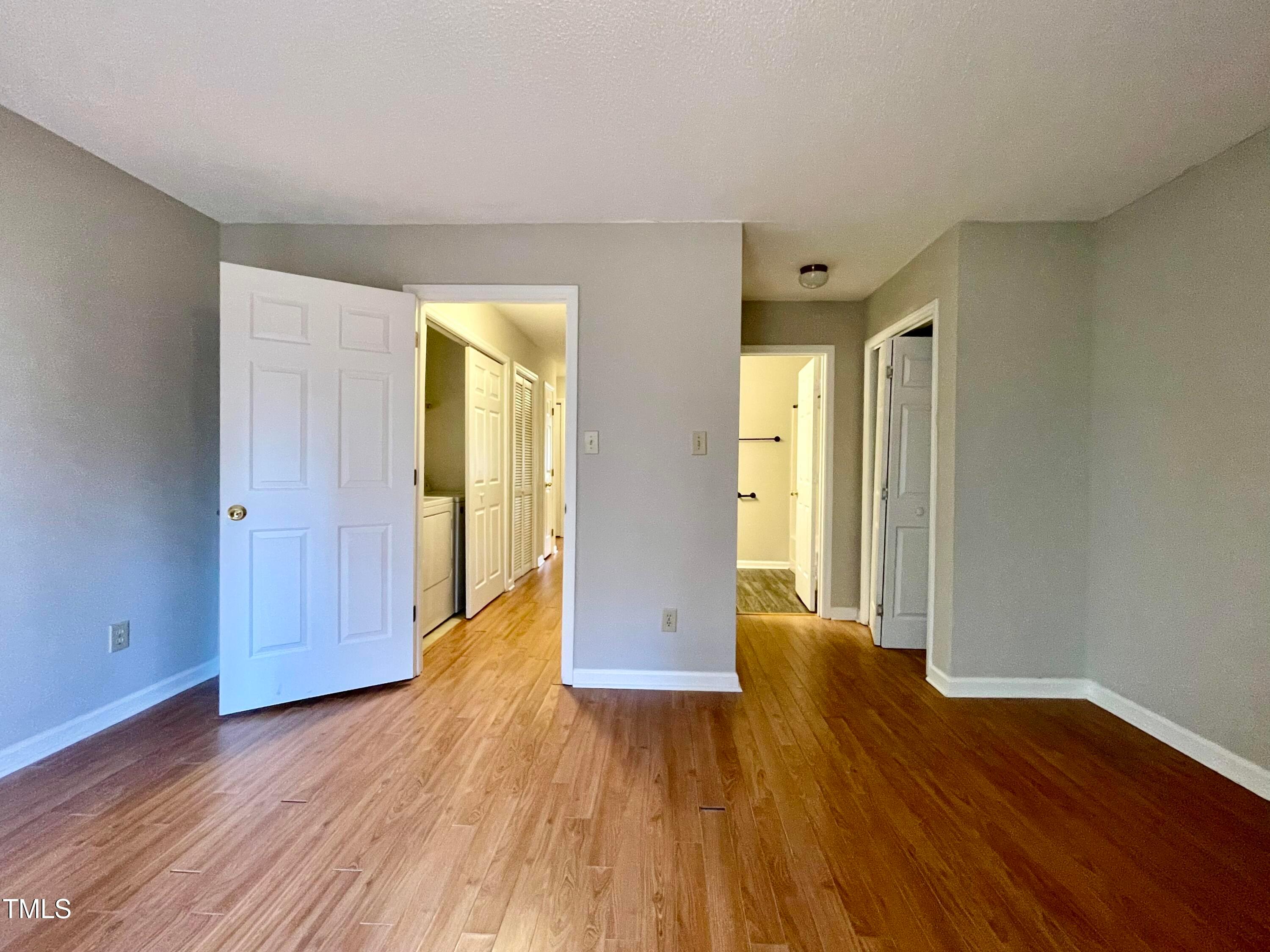 4114 Beechnut Lane Durham, NC 27707 - Photo 16 of 25 a view of an empty room with wooden floor and a window