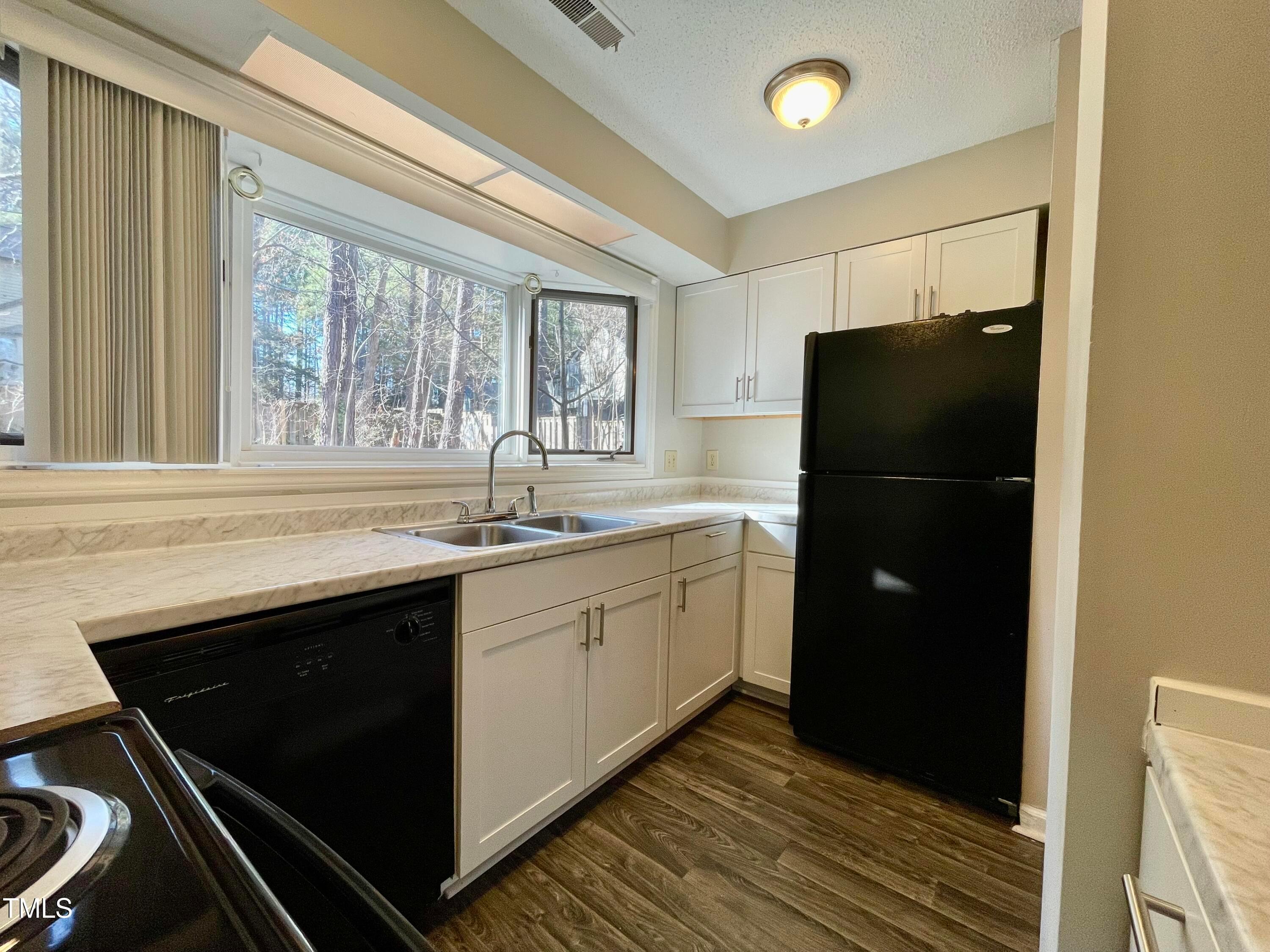 4114 Beechnut Lane Durham, NC 27707 - Photo 6 of 25 a kitchen with a refrigerator and a sink