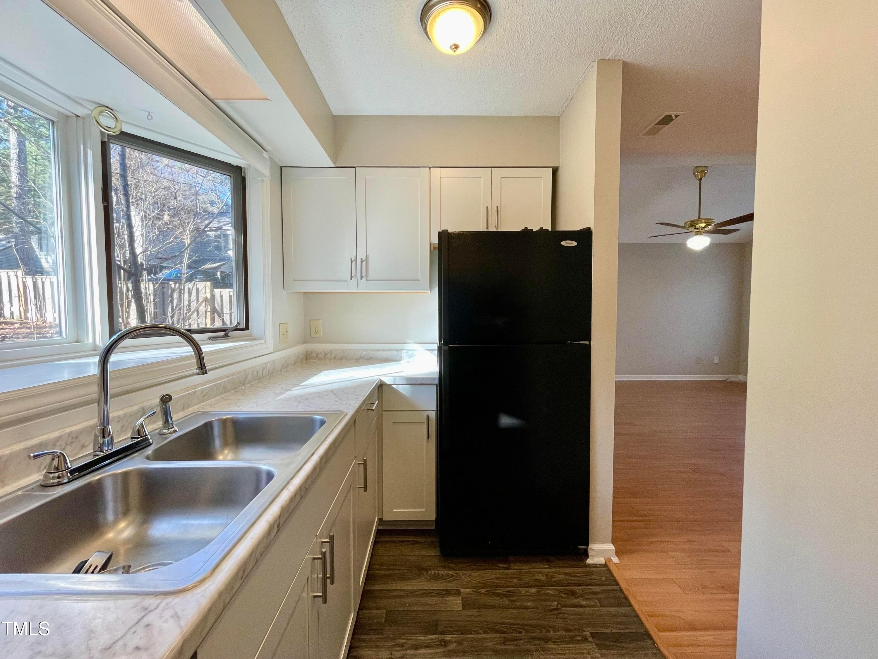 4114 Beechnut Lane Durham, NC 27707 - Photo 7 of 25 a kitchen with a refrigerator and a sink