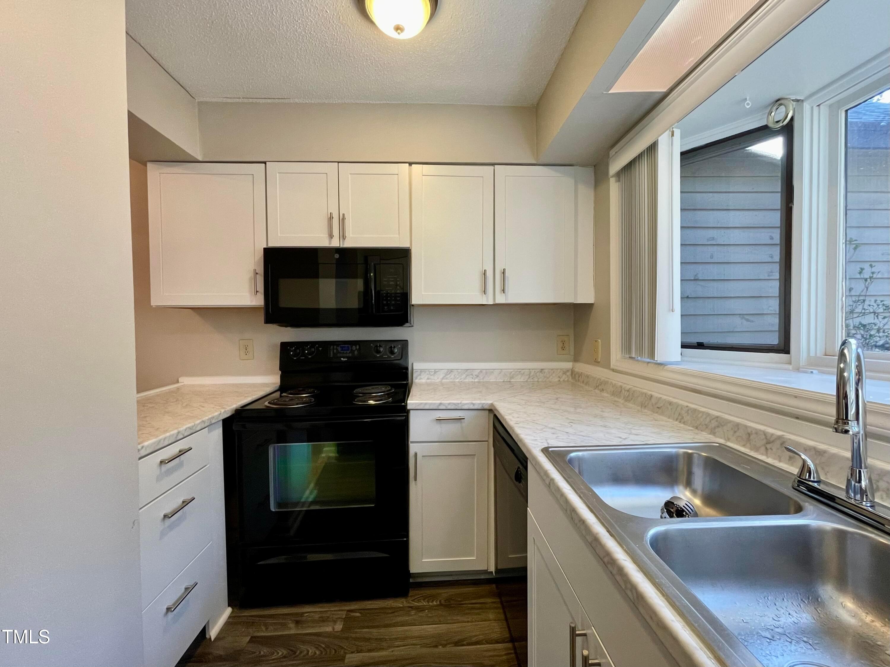 4114 Beechnut Lane Durham, NC 27707 - Photo 8 of 25 a kitchen with a sink stove and microwave