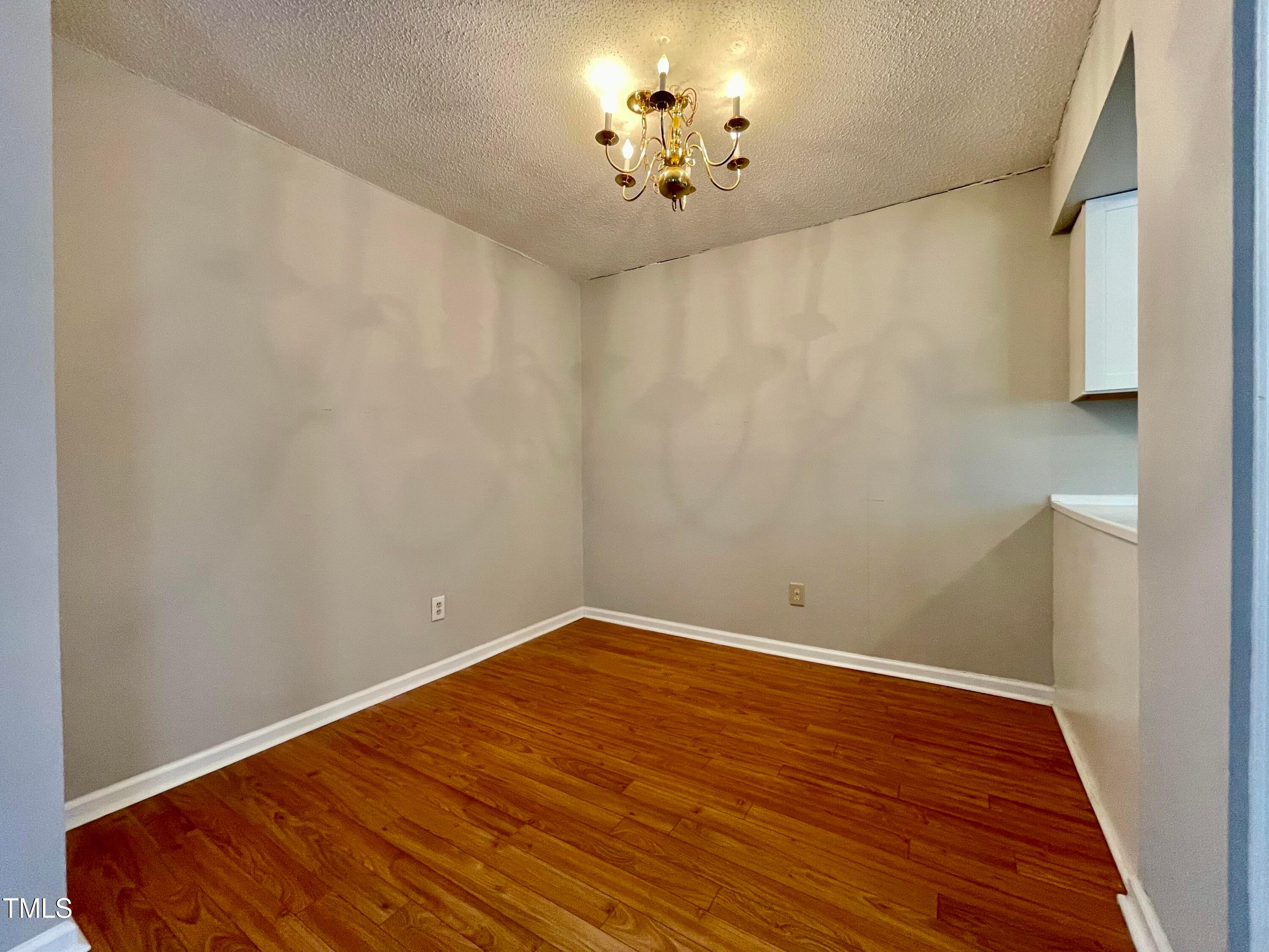 4114 Beechnut Lane Durham, NC 27707 - Photo 10 of 25 a view of empty room with wooden floor