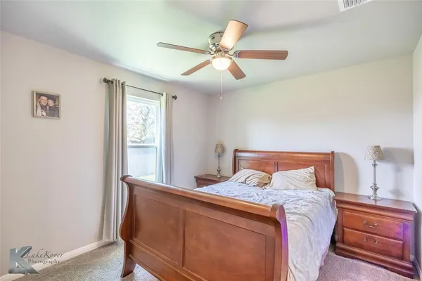 a bedroom with a large bed and a window