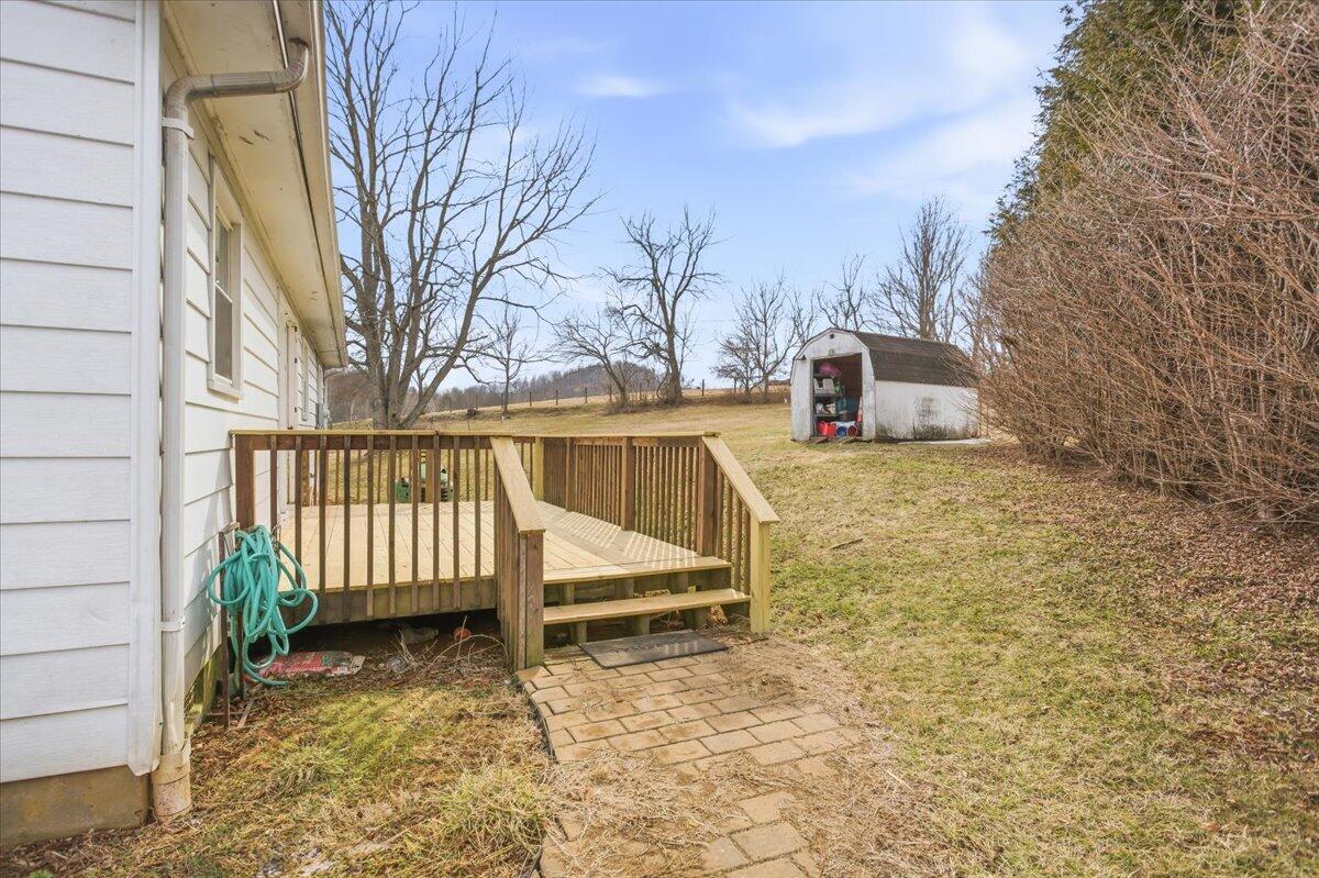 1249 Blue Ridge Turnpike Fincastle, VA 24090 - Photo 12 of 29 a view of a backyard with wooden fence and a bench