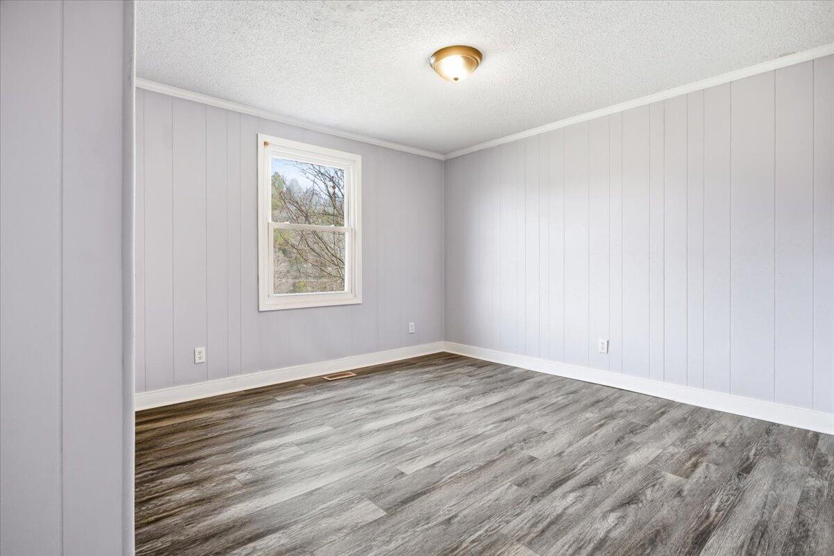 1249 Blue Ridge Turnpike Fincastle, VA 24090 - Photo 22 of 29 an empty room with wooden floor and windows