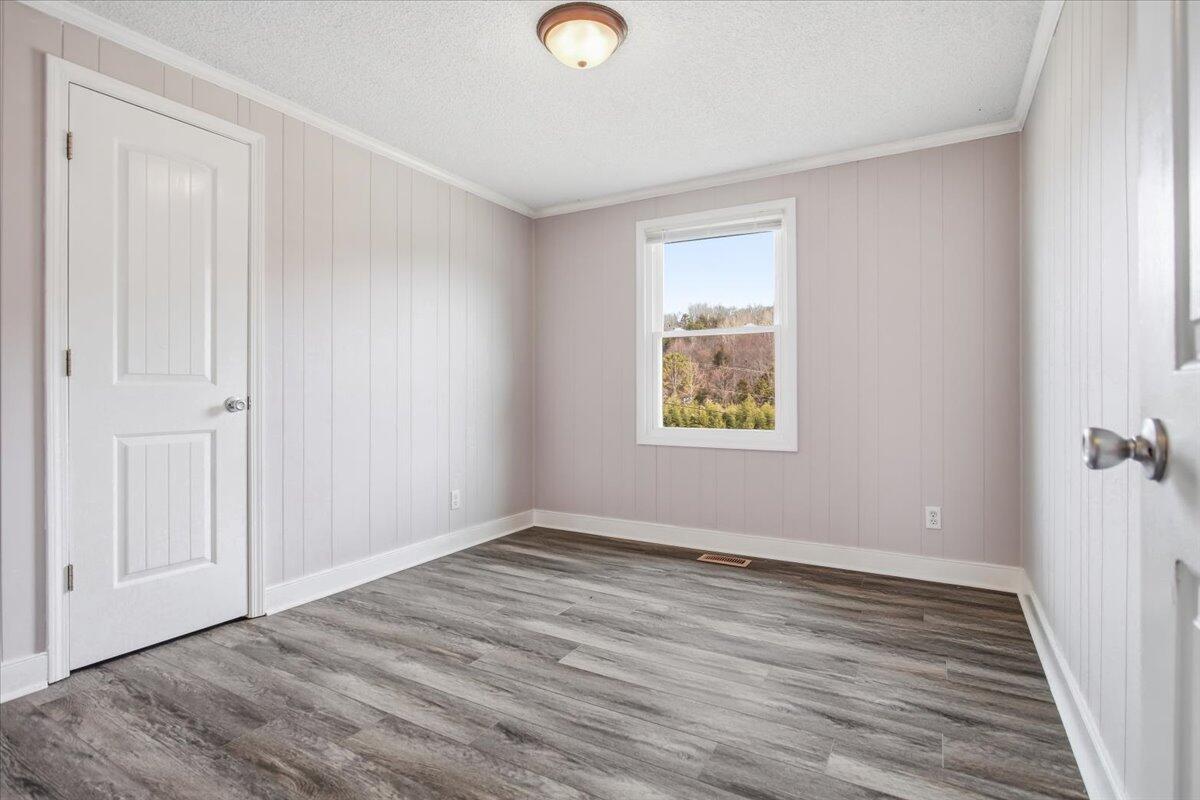 1249 Blue Ridge Turnpike Fincastle, VA 24090 - Photo 24 of 29 a view of an empty room with wooden floor and a window