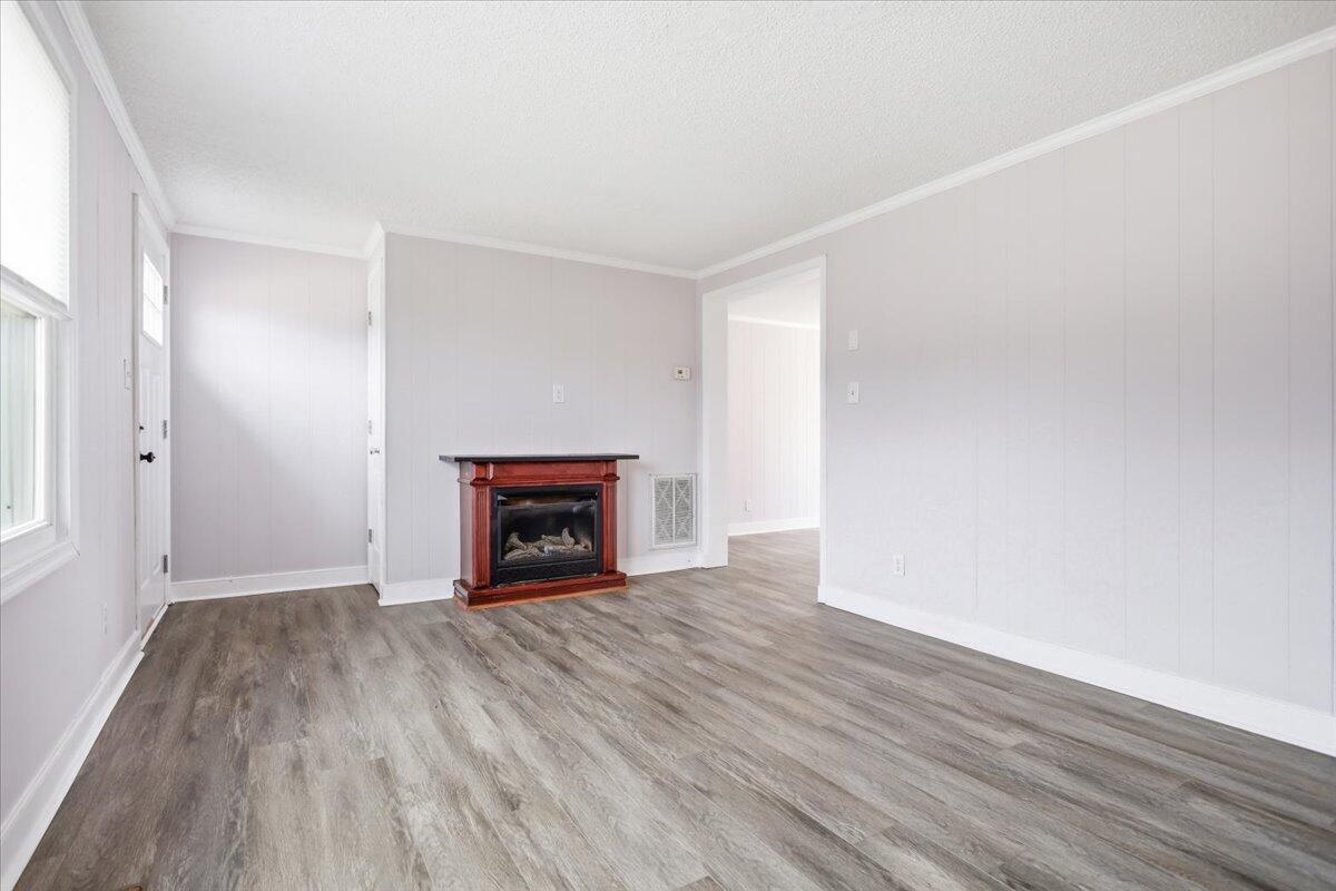 1249 Blue Ridge Turnpike Fincastle, VA 24090 - Photo 6 of 29 a view of an empty room with wooden floor fireplace and a window