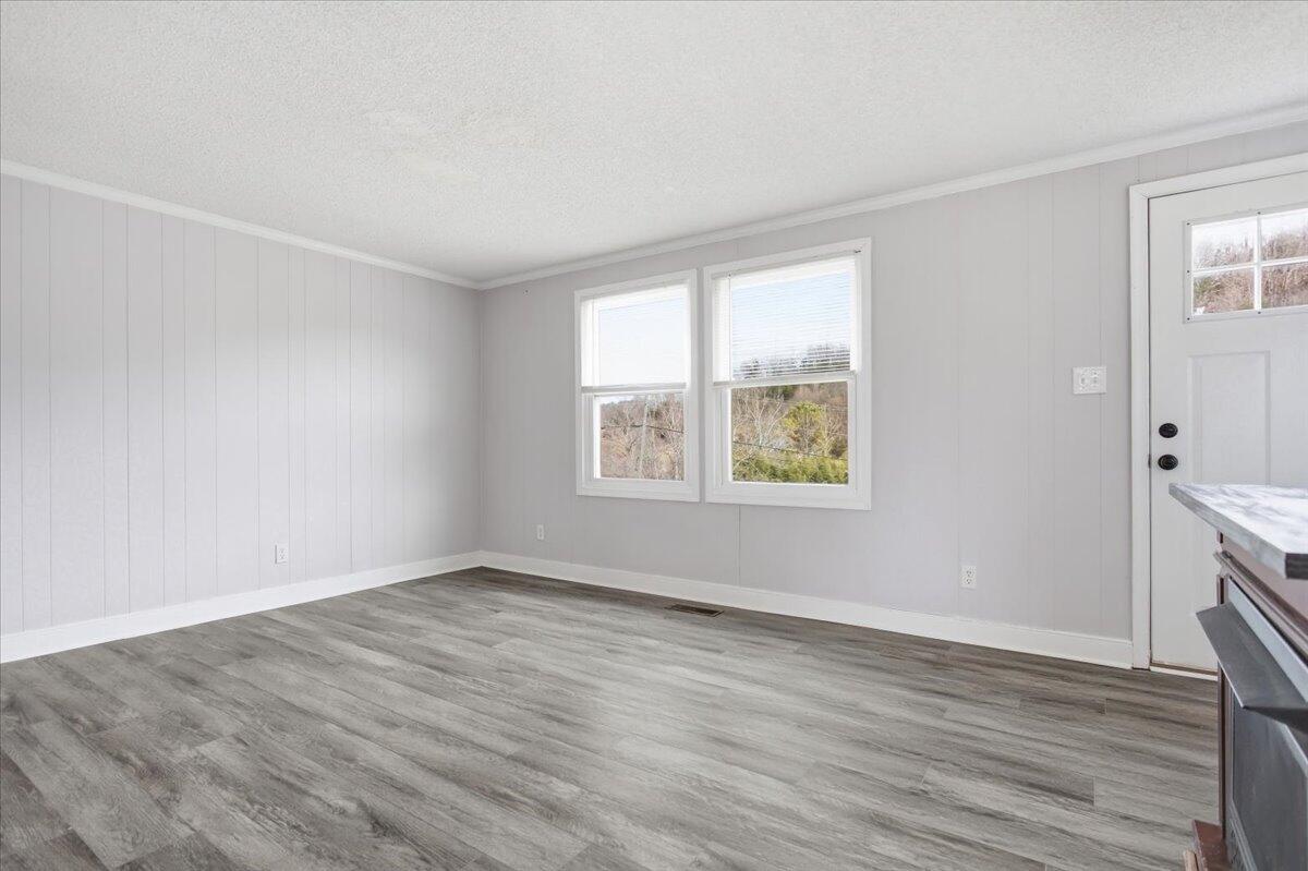1249 Blue Ridge Turnpike Fincastle, VA 24090 - Photo 7 of 29 an empty room with wooden floor and windows