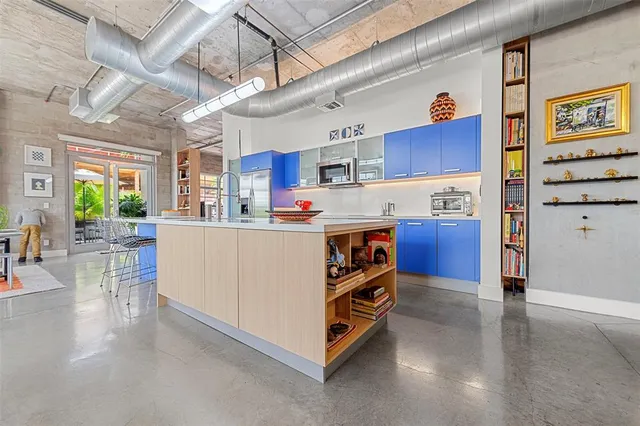 a kitchen with stainless steel appliances granite countertop a sink and wooden cabinets
