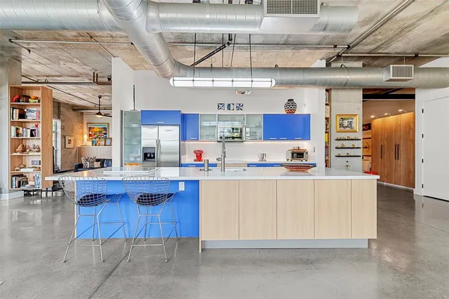 a living room with fireplace furniture and a large window