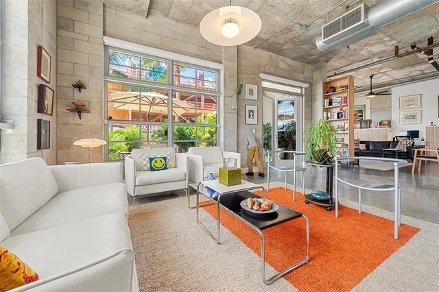 a living room with stainless steel appliances kitchen island granite countertop furniture and a kitchen view