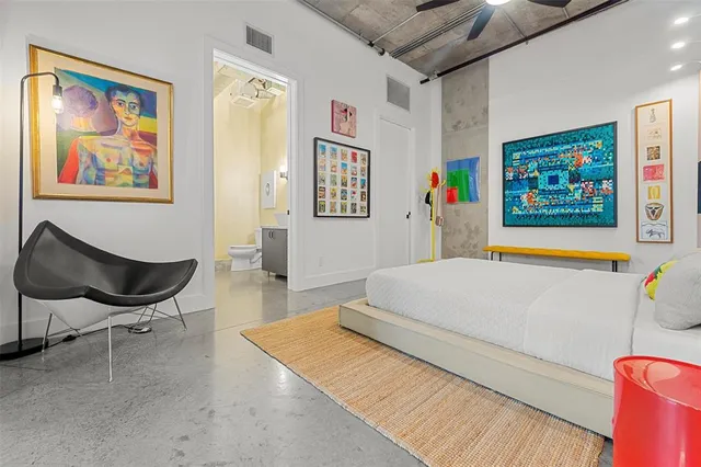 a bedroom with a bed and a large window