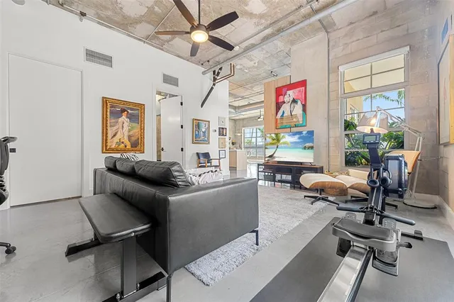 a living room with furniture and a floor to ceiling window
