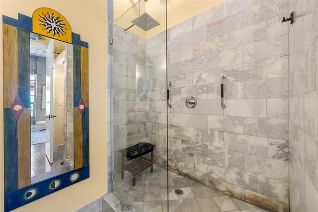 a view of a bathroom with washing machine and a mirror