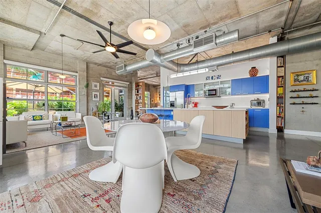 a living room with lots of furniture and a large window