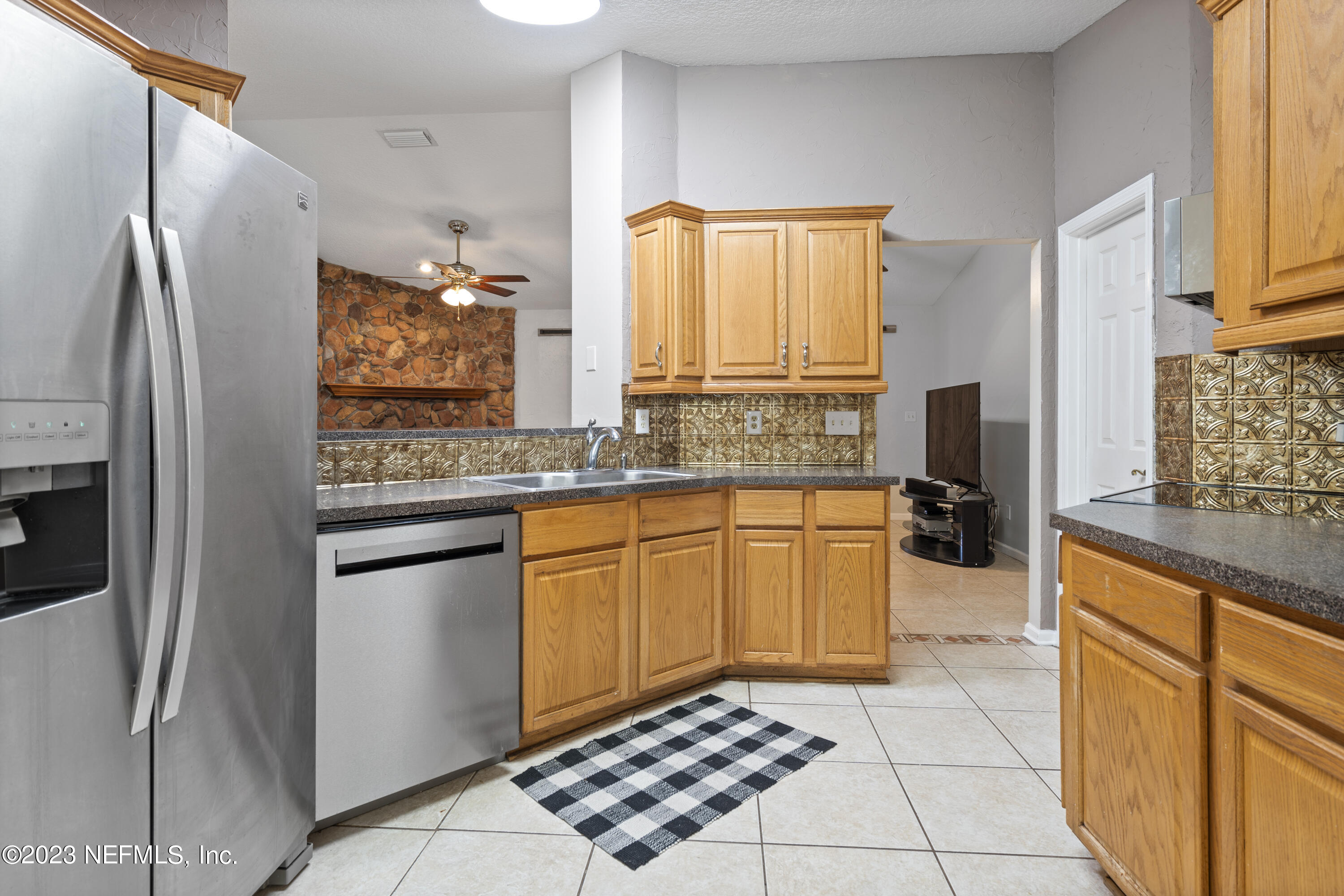 870 Fleming Street Fleming Island, FL 32003 - Photo 13 of 48 a kitchen with stainless steel appliances granite countertop a refrigerator and a stove top oven