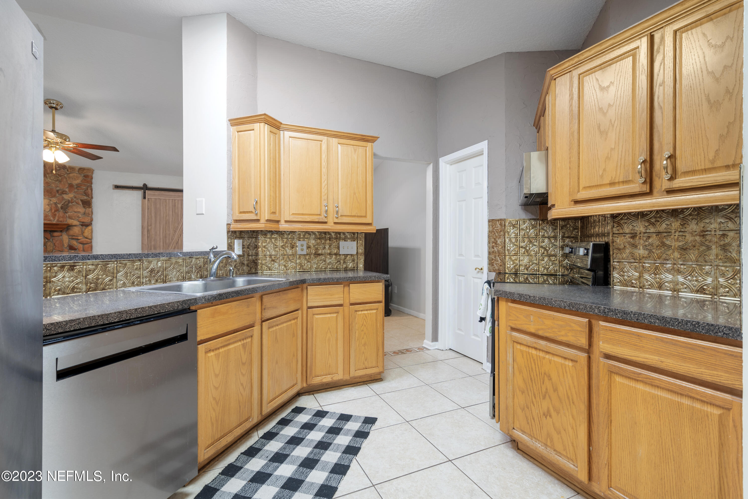 870 Fleming Street Fleming Island, FL 32003 - Photo 15 of 48 a kitchen with stainless steel appliances granite countertop a sink stove and cabinets