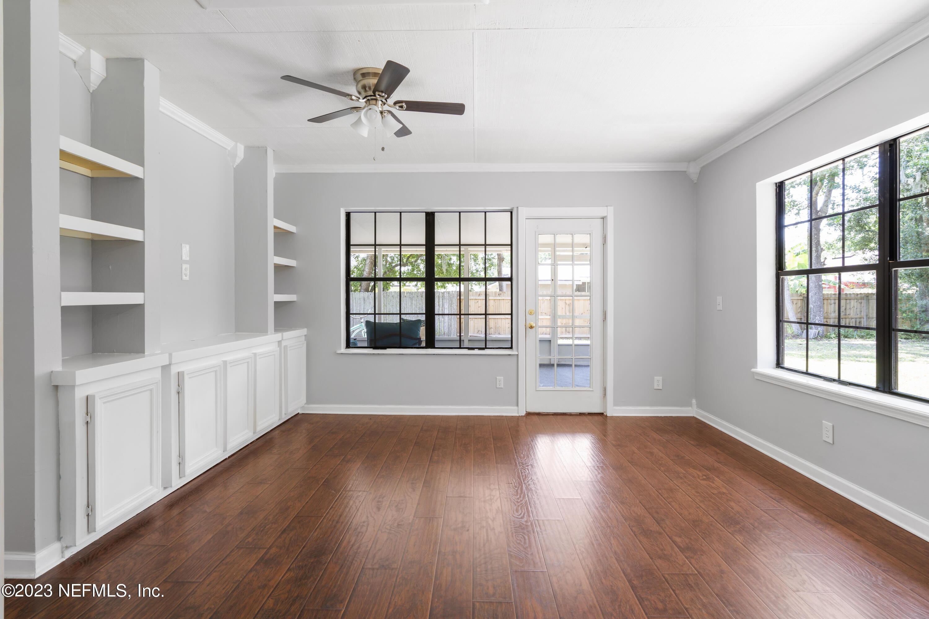 870 Fleming Street Fleming Island, FL 32003 - Photo 17 of 48 a view of an empty room with a window and wooden floor