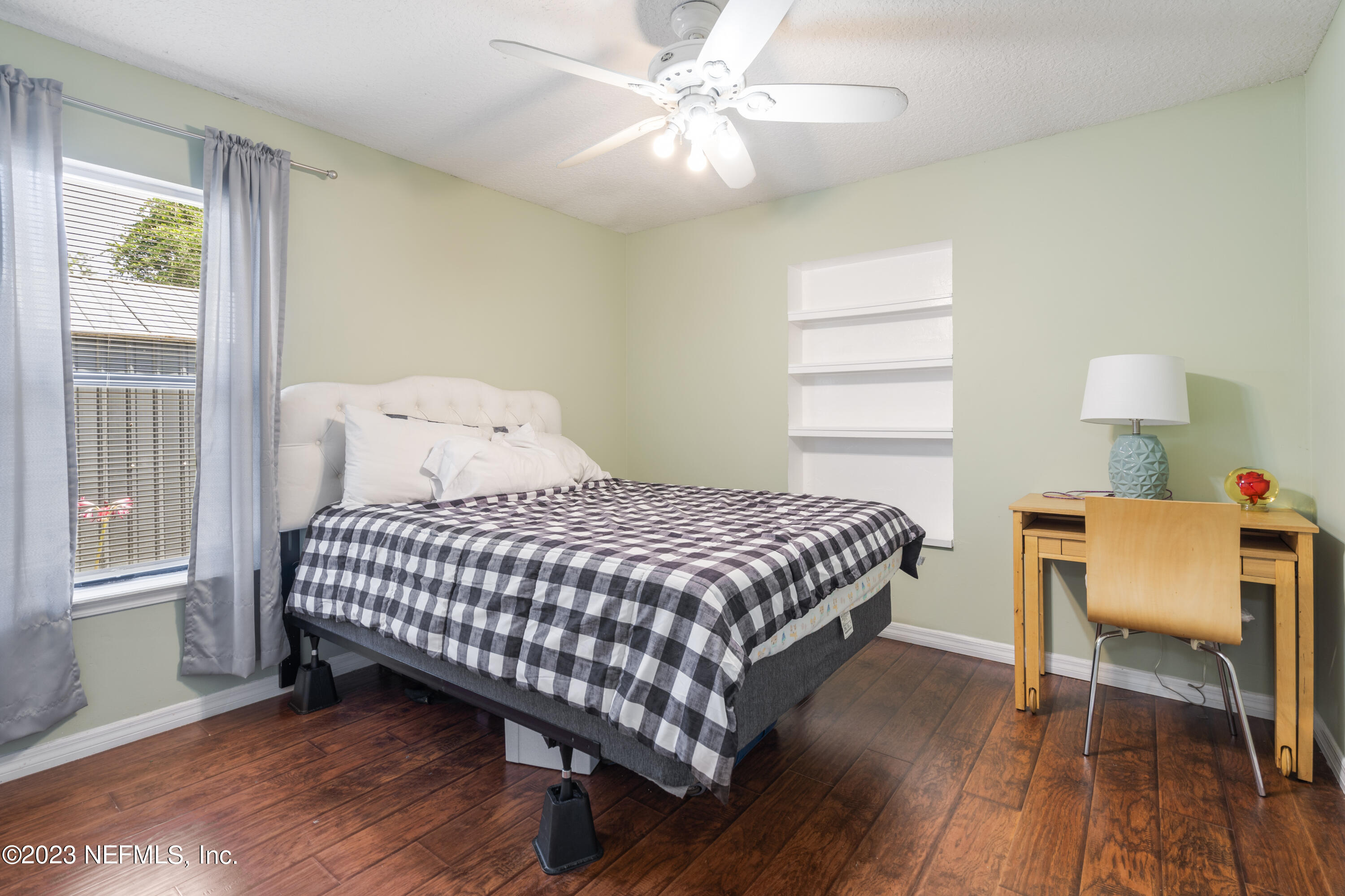 870 Fleming Street Fleming Island, FL 32003 - Photo 19 of 48 a bedroom with a bed a table and chair