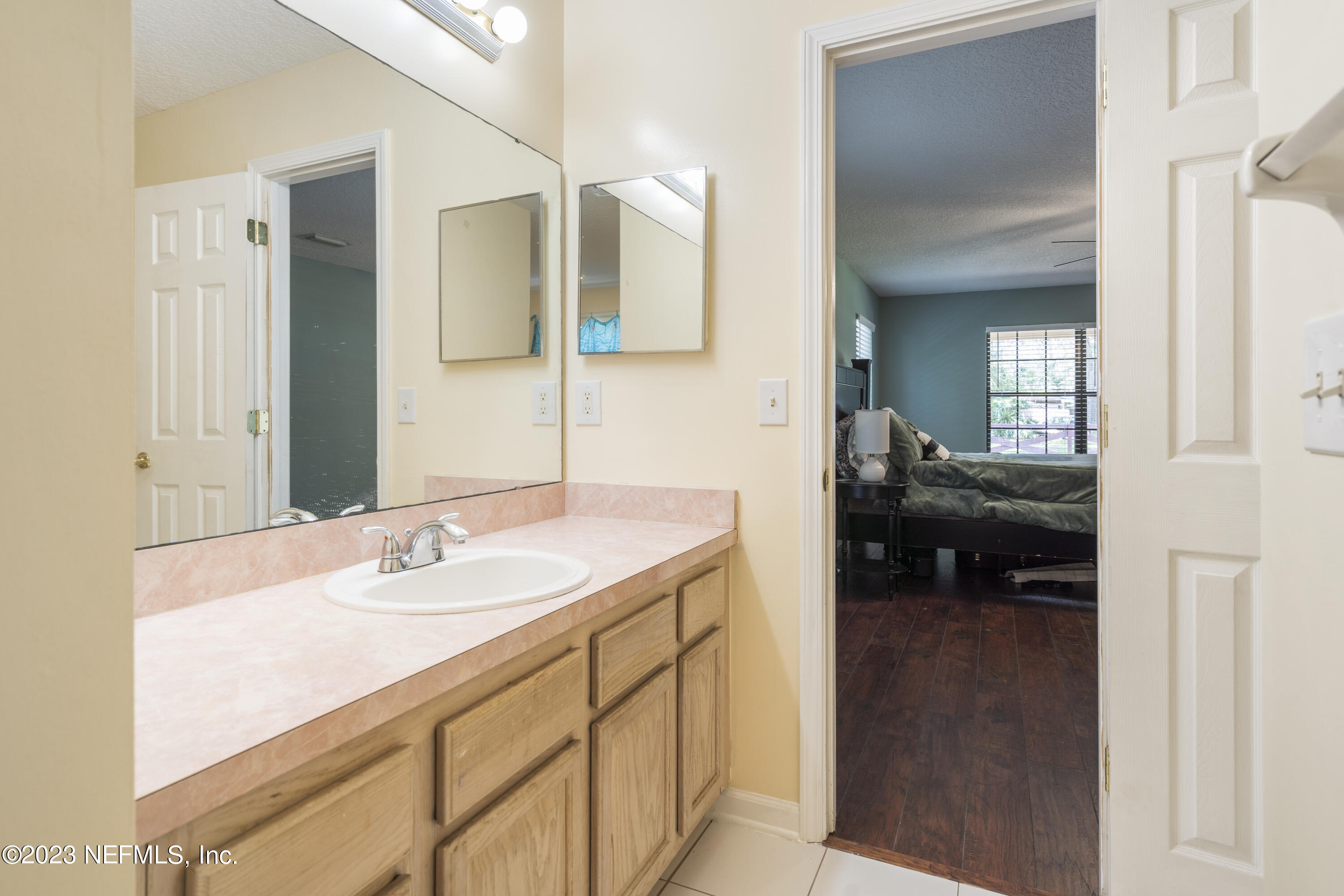 870 Fleming Street Fleming Island, FL 32003 - Photo 24 of 48 a en suite bathroom with a sink and a mirror