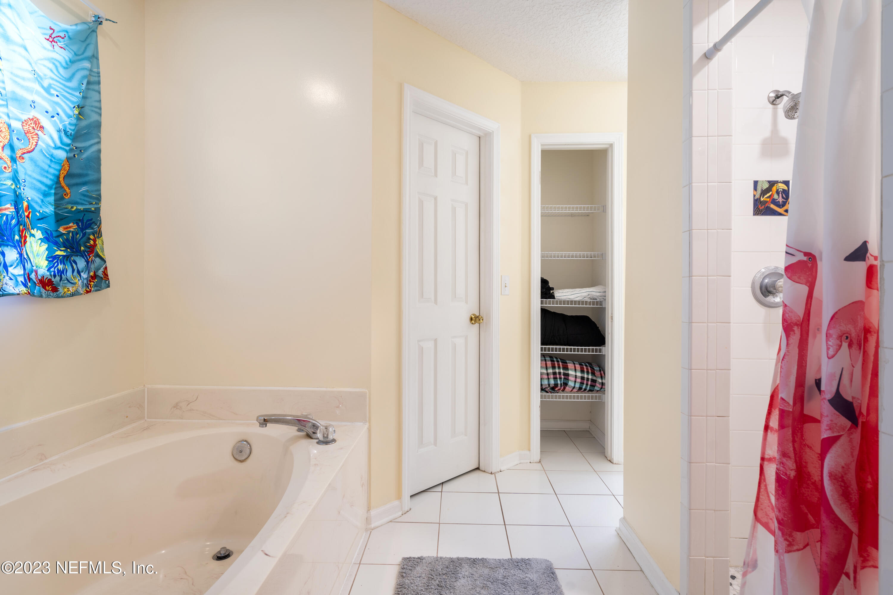 870 Fleming Street Fleming Island, FL 32003 - Photo 25 of 48 a bathroom with a bathtub and shower