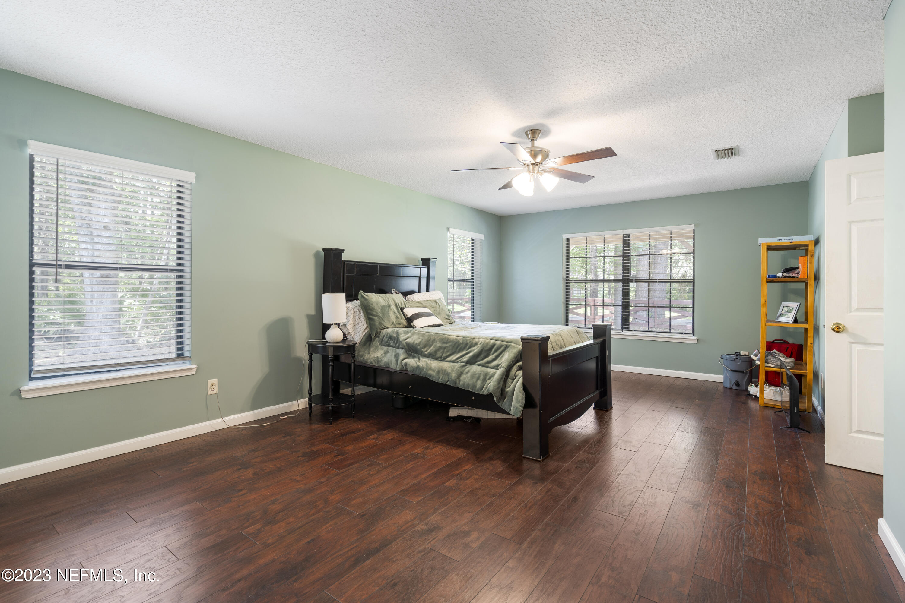 870 Fleming Street Fleming Island, FL 32003 - Photo 28 of 48 a bedroom with a bed and a chandelier