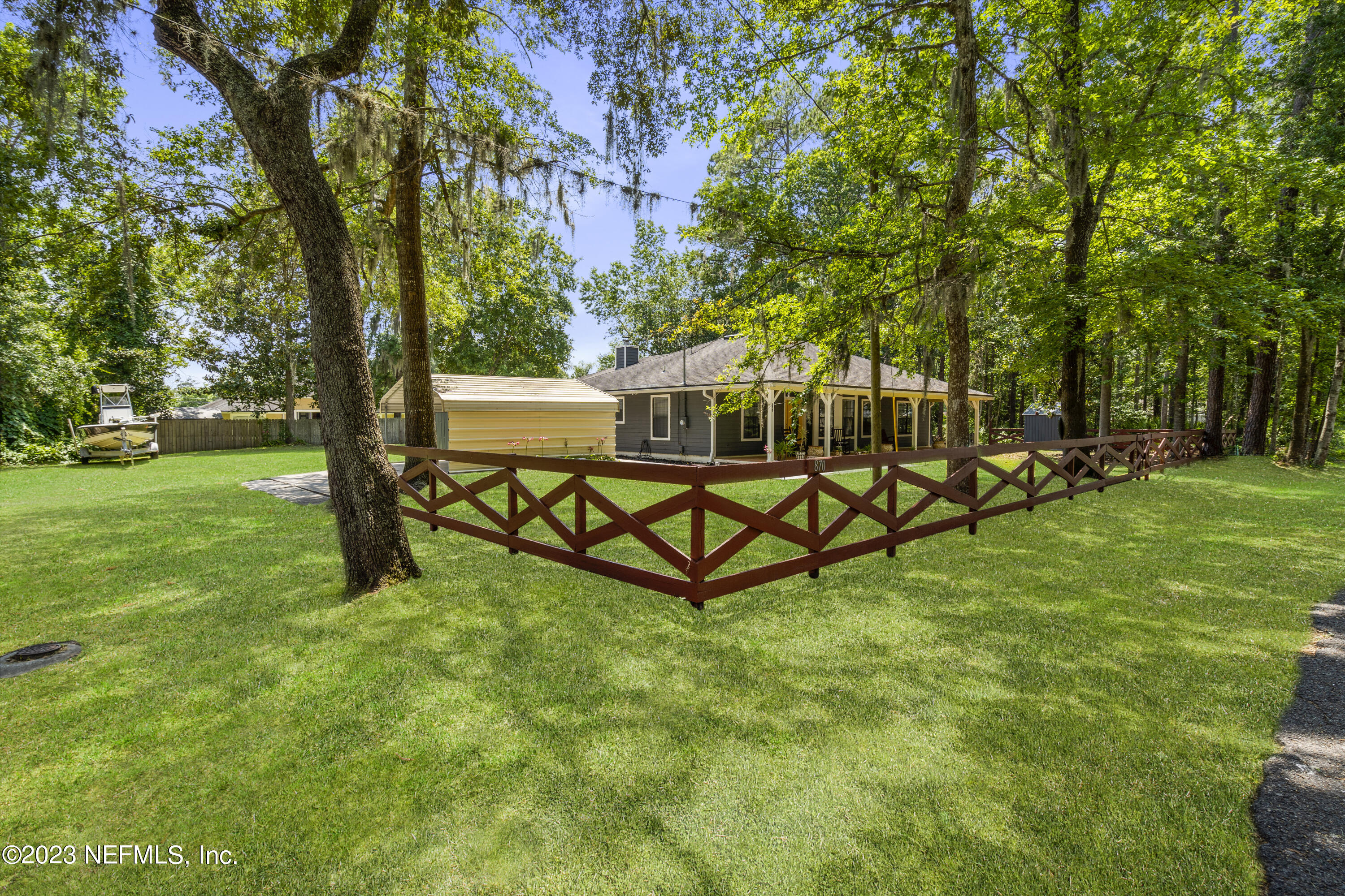 870 Fleming Street Fleming Island, FL 32003 - Photo 32 of 48 a view of backyard with a garden and trees