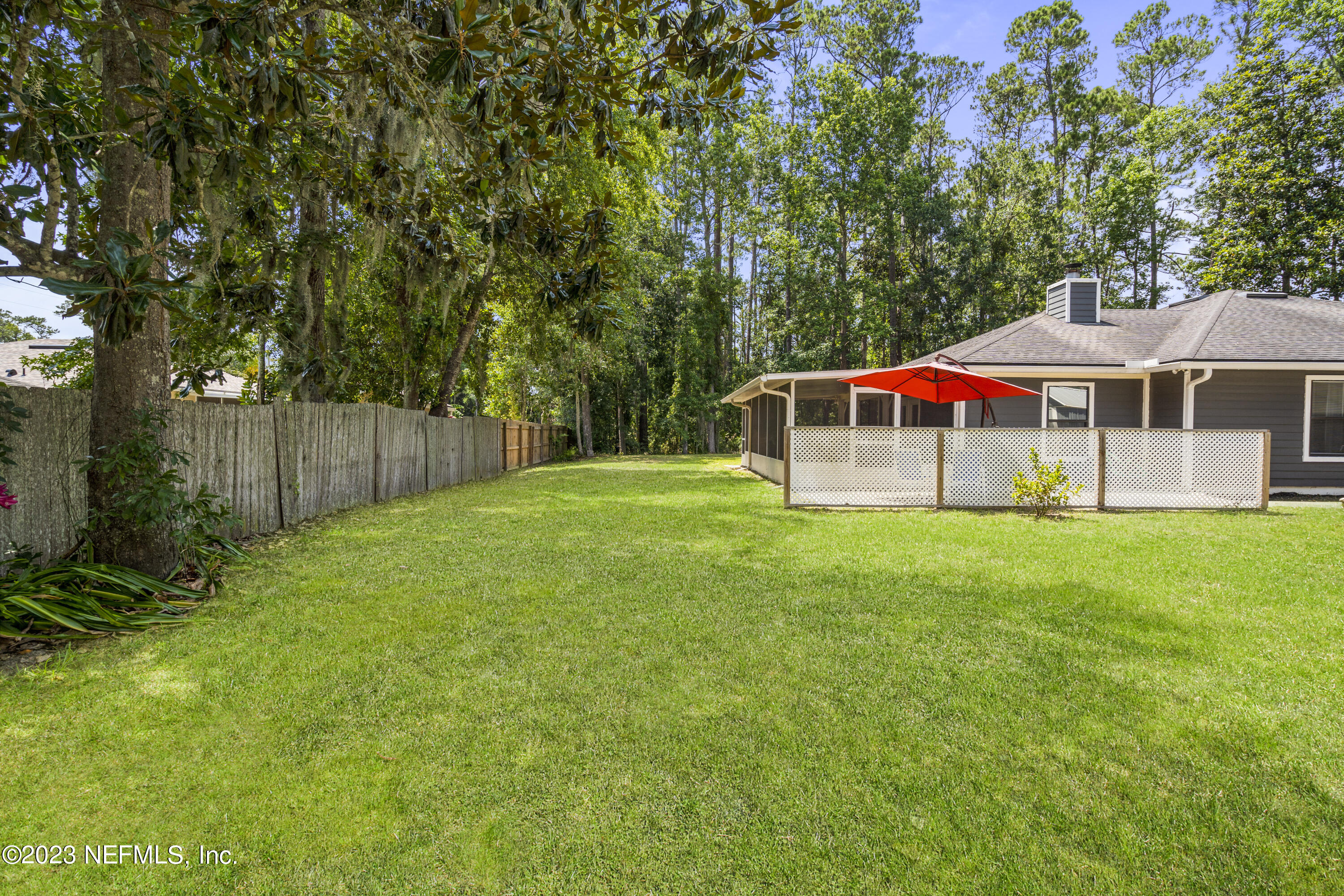 870 Fleming Street Fleming Island, FL 32003 - Photo 33 of 48 a view of an house with backyard and a tree