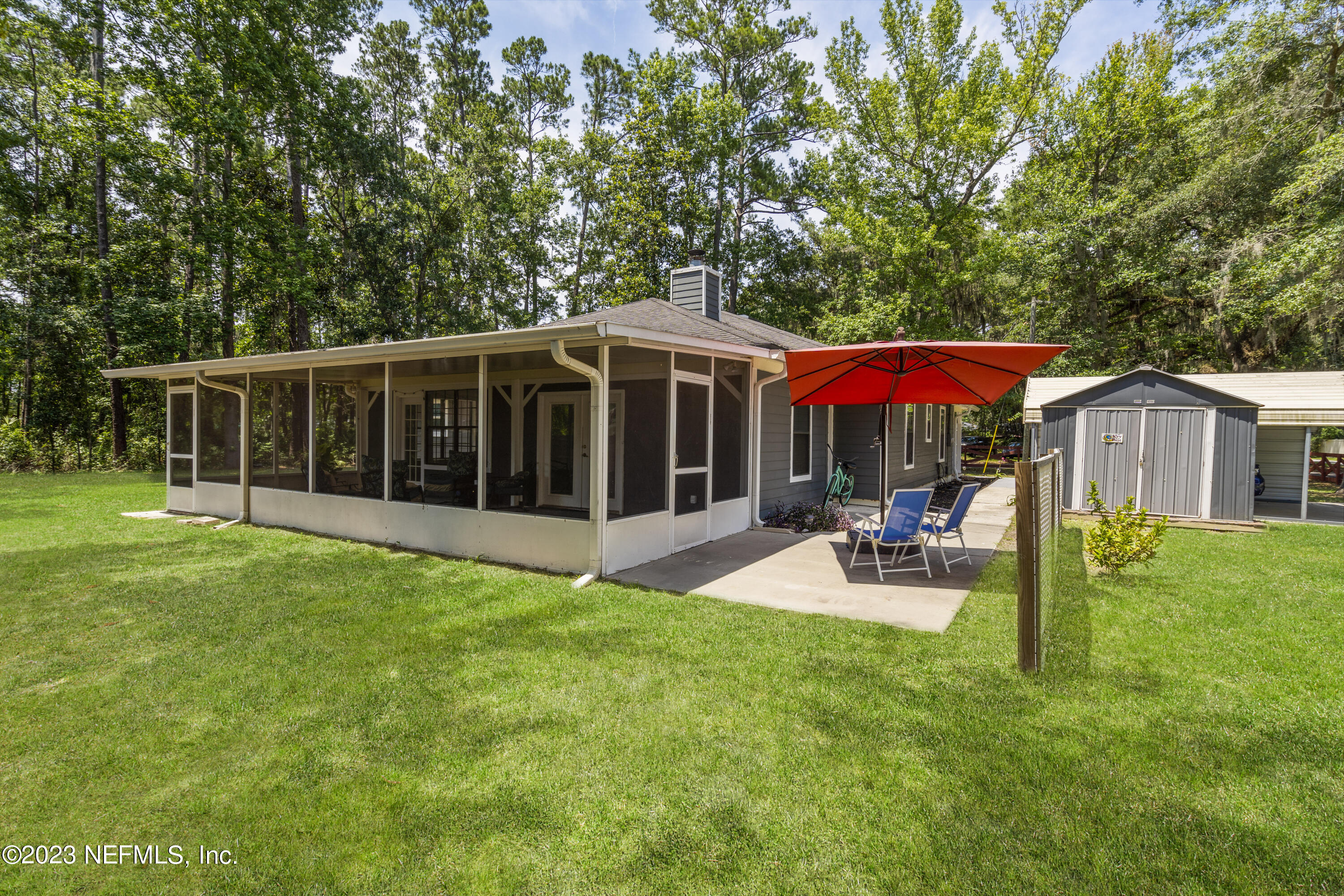 870 Fleming Street Fleming Island, FL 32003 - Photo 35 of 48 a view of a house with backyard and sitting area