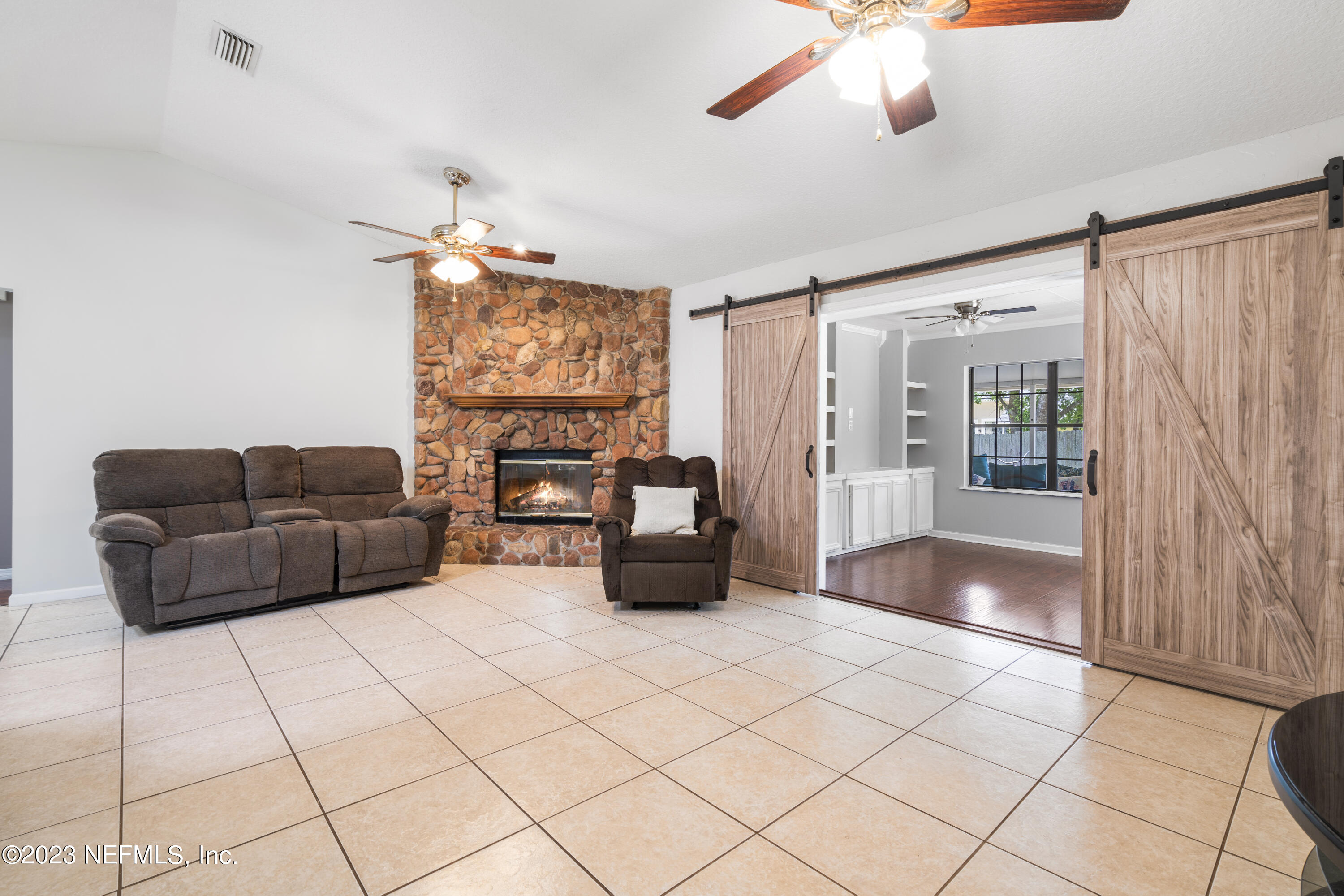870 Fleming Street Fleming Island, FL 32003 - Photo 4 of 48 a living room with furniture and a flat screen tv