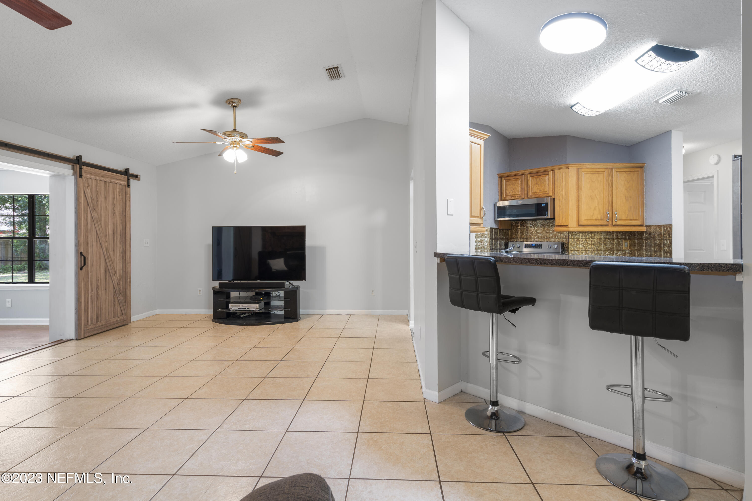 870 Fleming Street Fleming Island, FL 32003 - Photo 6 of 48 a view of a livingroom with furniture and a flat screen tv