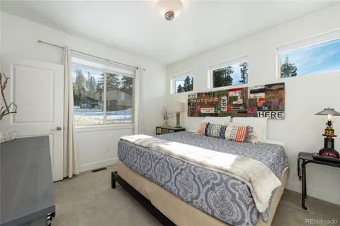 a bed sitting in a bedroom next to a window