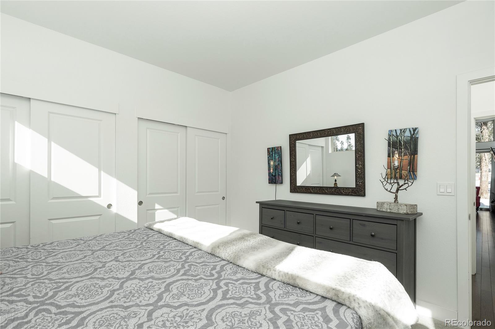 40 Journey Way Fraser, CO 80442 - Photo 15 of 41 a bedroom with a bed and a bathroom with mirror
